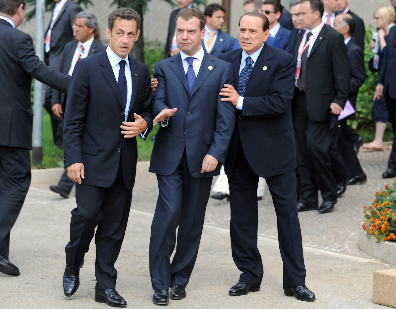 (L to R) French President Nicolas Sarkozy, Russian President Dmitri Medvedev, and Italian Prime Minister Silvio Berlusconi arrive to pose for a family photo at the Group of Eight (G8) summit in L'Aquila, central Italy, on July 8, 2009. Group of Eight leaders kick off talks today on issues ranging from the global financial crisis to climate change to the situations in Iran and Xinjiang, China. AFP PHOTO DDP/ POOL/ PEER GRIMM GERMANY OUT